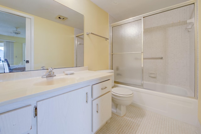 full bathroom featuring vanity, bath / shower combo with glass door, toilet, and tile patterned floors