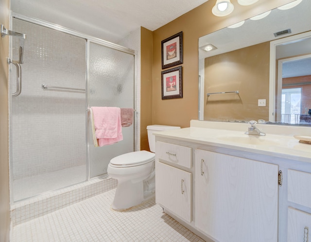 bathroom featuring vanity, tile patterned flooring, toilet, and an enclosed shower