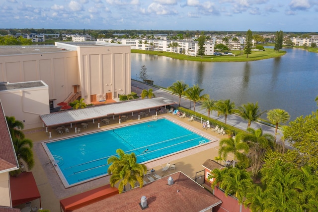 view of pool with a water view and a patio