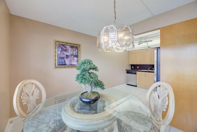 tiled dining space featuring sink and a notable chandelier