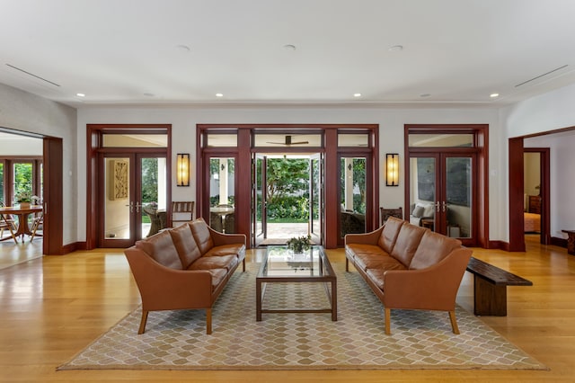 living room with french doors and light hardwood / wood-style flooring