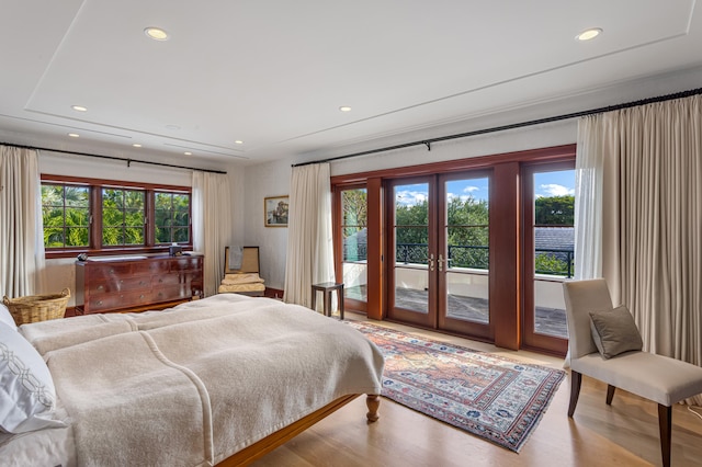 bedroom featuring french doors, access to outside, and wood-type flooring