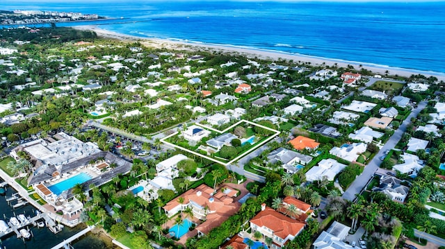 drone / aerial view with a water view and a view of the beach