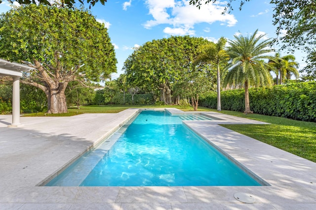 view of pool featuring a lawn