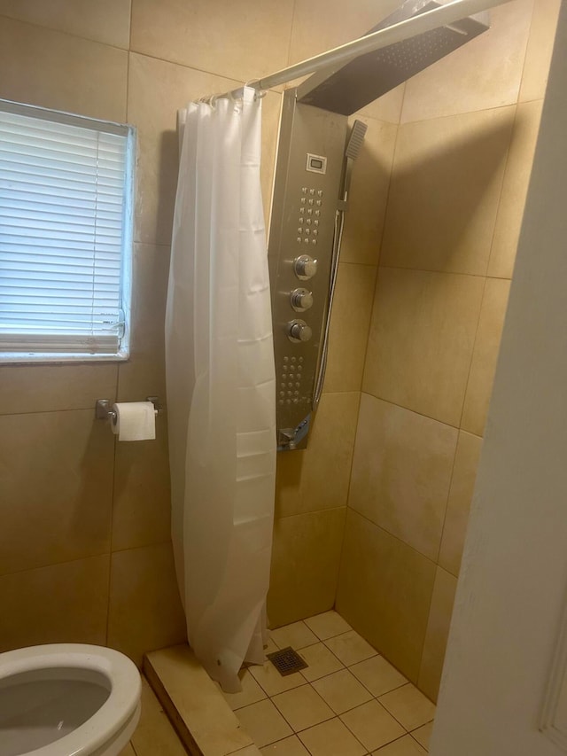 bathroom featuring tile patterned flooring, walk in shower, and toilet