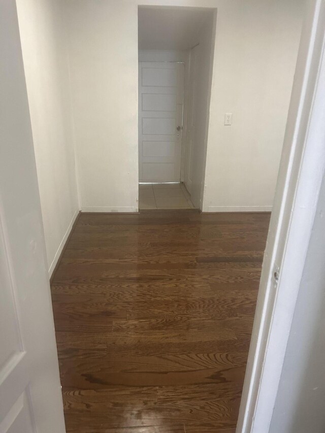 hallway with dark hardwood / wood-style floors