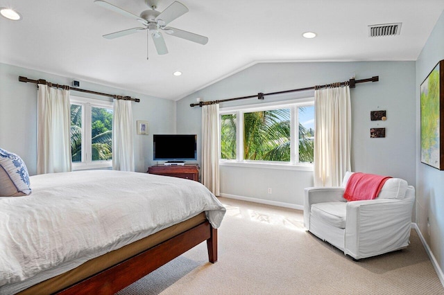 bedroom with ceiling fan, light colored carpet, lofted ceiling, and multiple windows