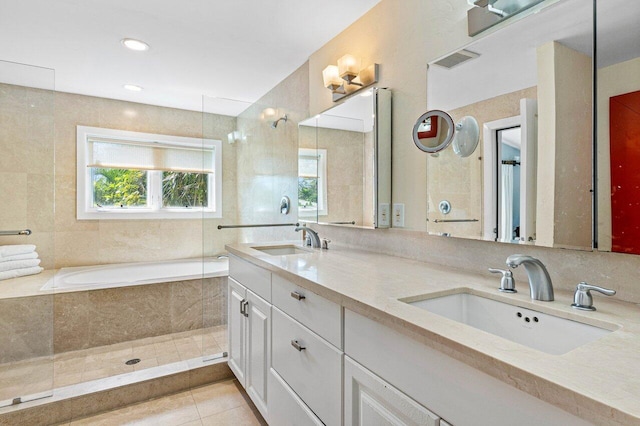 bathroom with shower with separate bathtub, tile patterned flooring, and vanity