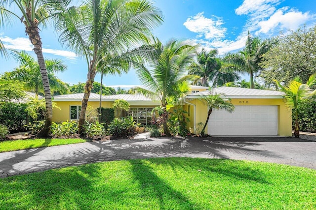 ranch-style home with a garage and a front yard