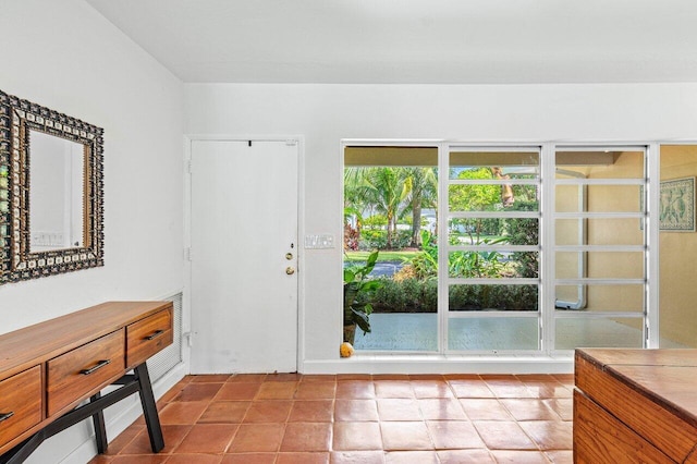 doorway to outside with light tile patterned flooring