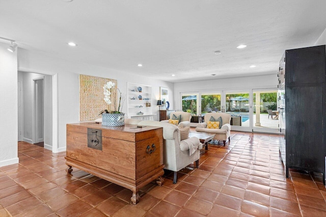 living room featuring built in shelves and tile patterned floors