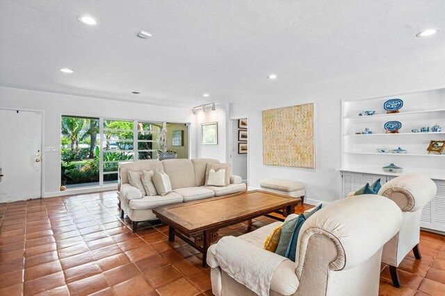 living room with tile patterned flooring and a textured ceiling