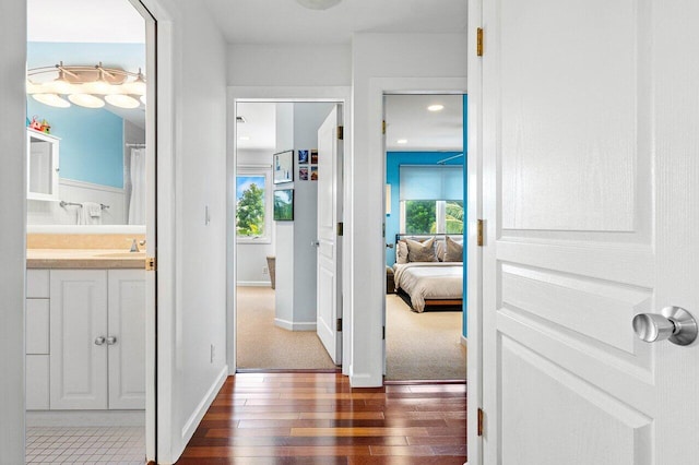 hallway with sink and dark hardwood / wood-style flooring