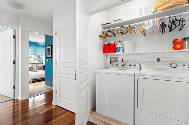 laundry room featuring washer and clothes dryer and wood-type flooring