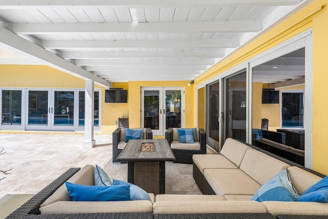 view of patio / terrace with an outdoor living space with a fire pit and french doors