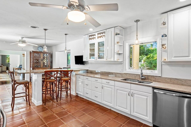 kitchen featuring white cabinets, dishwasher, decorative light fixtures, and sink