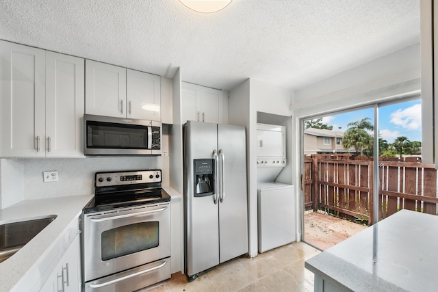 kitchen with white cabinetry, stacked washer and clothes dryer, a textured ceiling, and stainless steel appliances