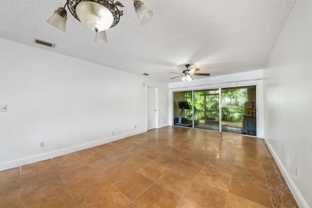 unfurnished room with ceiling fan and a textured ceiling