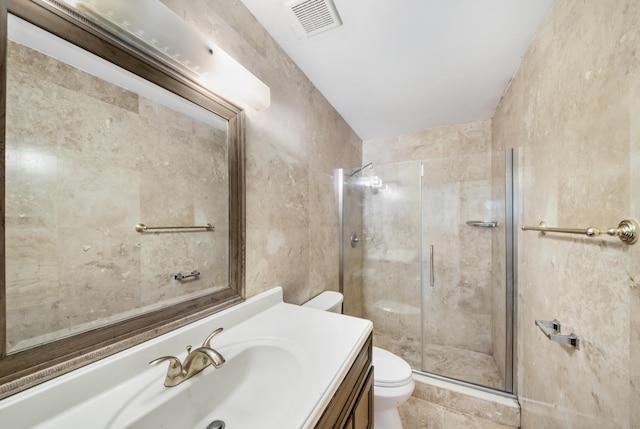 bathroom featuring toilet, vanity, and walk in shower