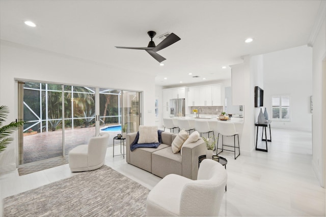 living room with ceiling fan and sink