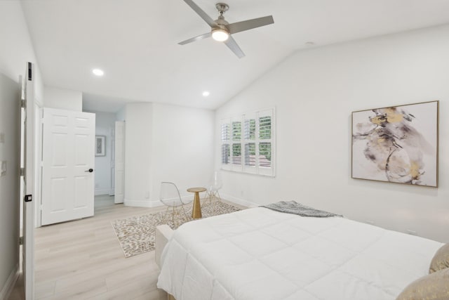 bedroom with ceiling fan, vaulted ceiling, and light hardwood / wood-style floors