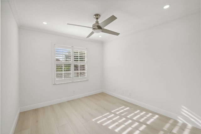 empty room with ceiling fan, ornamental molding, and light hardwood / wood-style floors