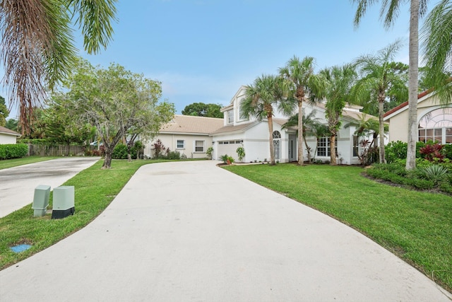 view of front of house with a garage and a front lawn