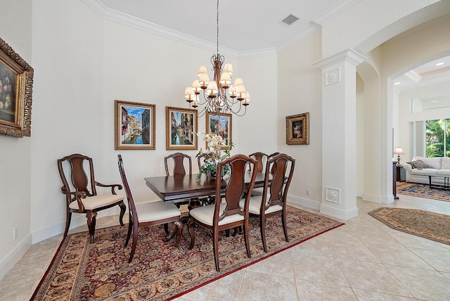 tiled dining area featuring a notable chandelier, ornate columns, and crown molding