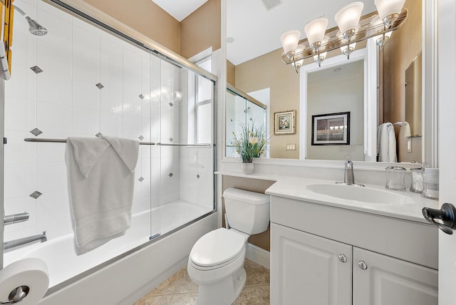 full bathroom featuring enclosed tub / shower combo, vanity, toilet, and tile patterned floors