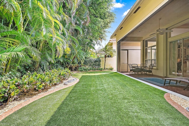 view of yard with ceiling fan and a patio area