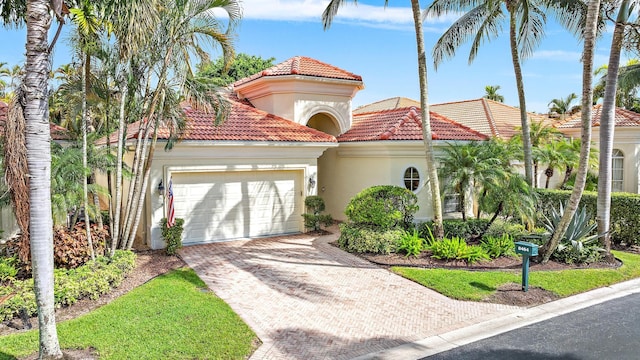 mediterranean / spanish house with a garage