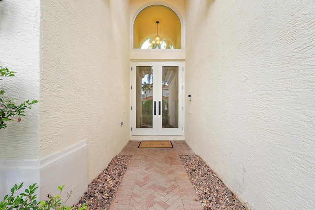 view of exterior entry featuring french doors