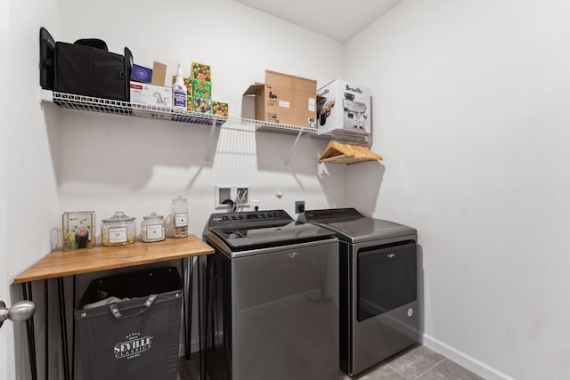 laundry area featuring light tile patterned floors and washer and dryer