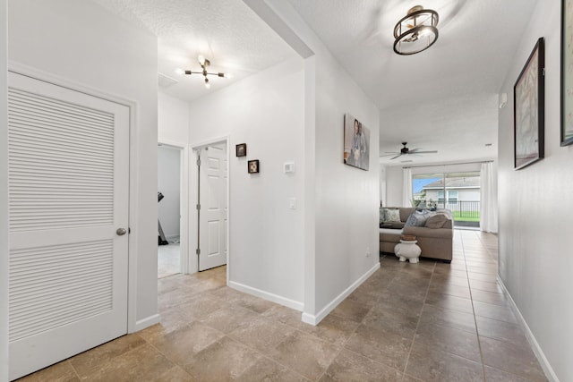 hallway featuring a textured ceiling