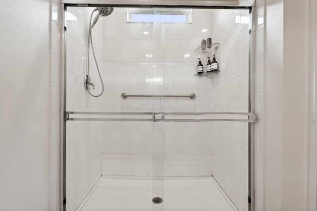 bathroom with a shower with shower door