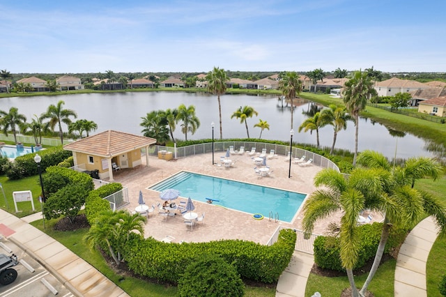 view of pool featuring a water view and a patio