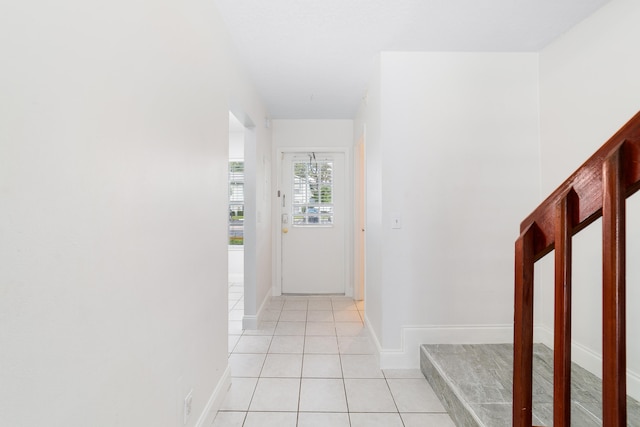 hall featuring light tile patterned floors