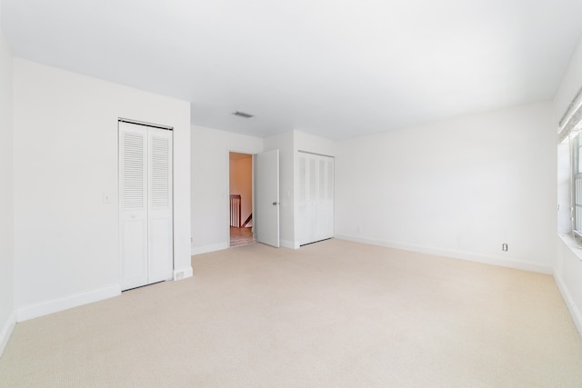 spare room featuring light colored carpet