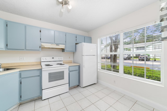 kitchen with white appliances, light tile patterned floors, and a healthy amount of sunlight