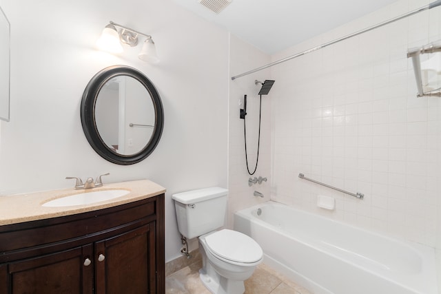 full bathroom with tile patterned flooring, tiled shower / bath combo, vanity, and toilet