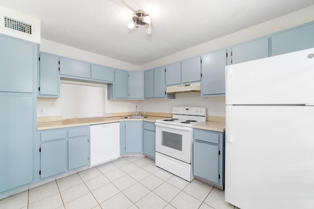 kitchen featuring blue cabinets, white appliances, a textured ceiling, and sink