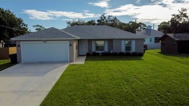 single story home featuring a front yard and a garage