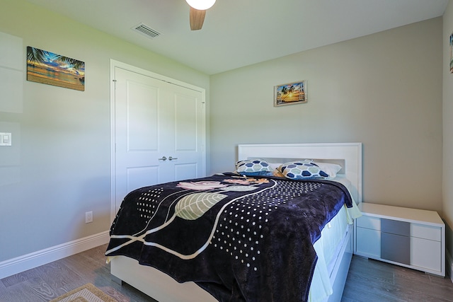 bedroom featuring ceiling fan, a closet, and dark hardwood / wood-style flooring