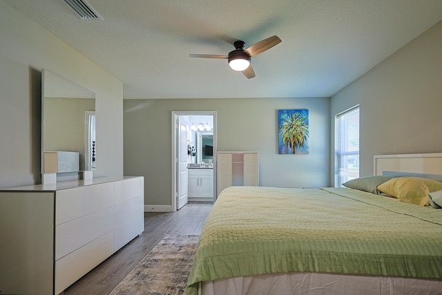 bedroom featuring ceiling fan, hardwood / wood-style floors, and ensuite bathroom