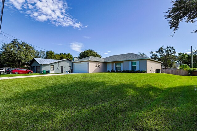 ranch-style house with a garage, central AC, and a front lawn