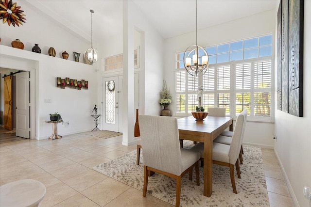 dining room with a chandelier, light tile patterned floors, and high vaulted ceiling