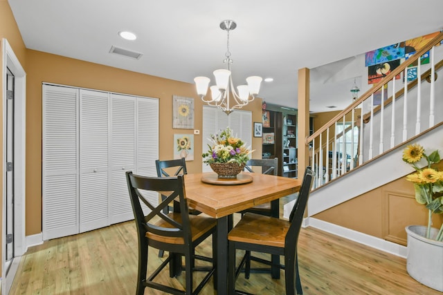 dining room with an inviting chandelier and light hardwood / wood-style floors