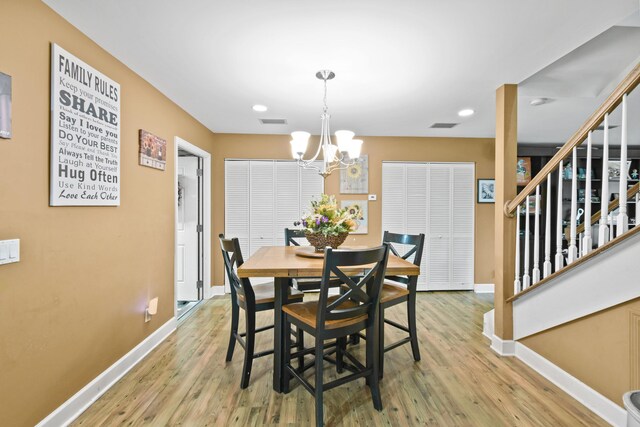 dining room featuring an inviting chandelier and hardwood / wood-style flooring