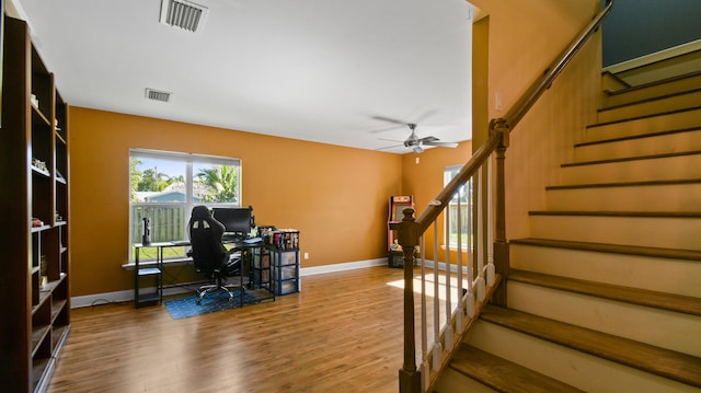 home office featuring wood-type flooring and ceiling fan