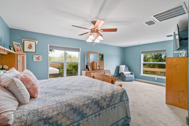 bedroom featuring multiple windows, carpet floors, and ceiling fan